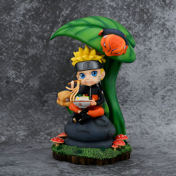 Naruto Uzumaki, le protagoniste de l'anime Naruto, assis sur un rocher sous une feuille de lotus en train de manger des ramen avec ses amis Gamakichi et Gamabunta.