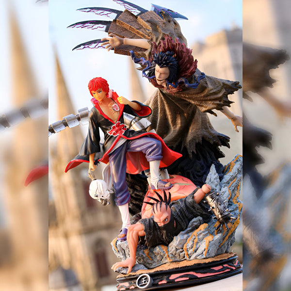 Figurines de collection Naruto représentant Pain, Konan et un membre d'Akatsuki. Les figurines sont en position de combat sur un socle rocheux.