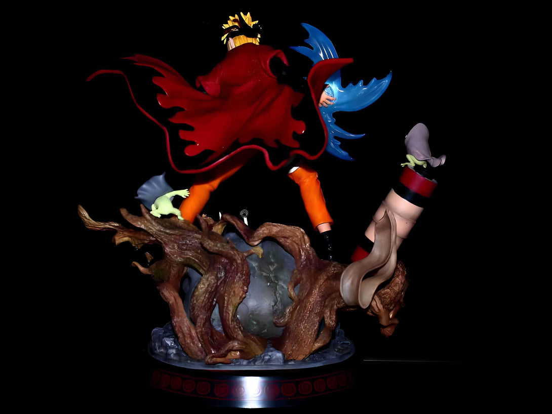 Statue de Naruto Uzumaki en mode sage des six chemins, avec son manteau rouge et ses invocations : Gamakichi, Katsuyu et Kurama. La figurine est posée sur un socle en bois représentant un arbre.