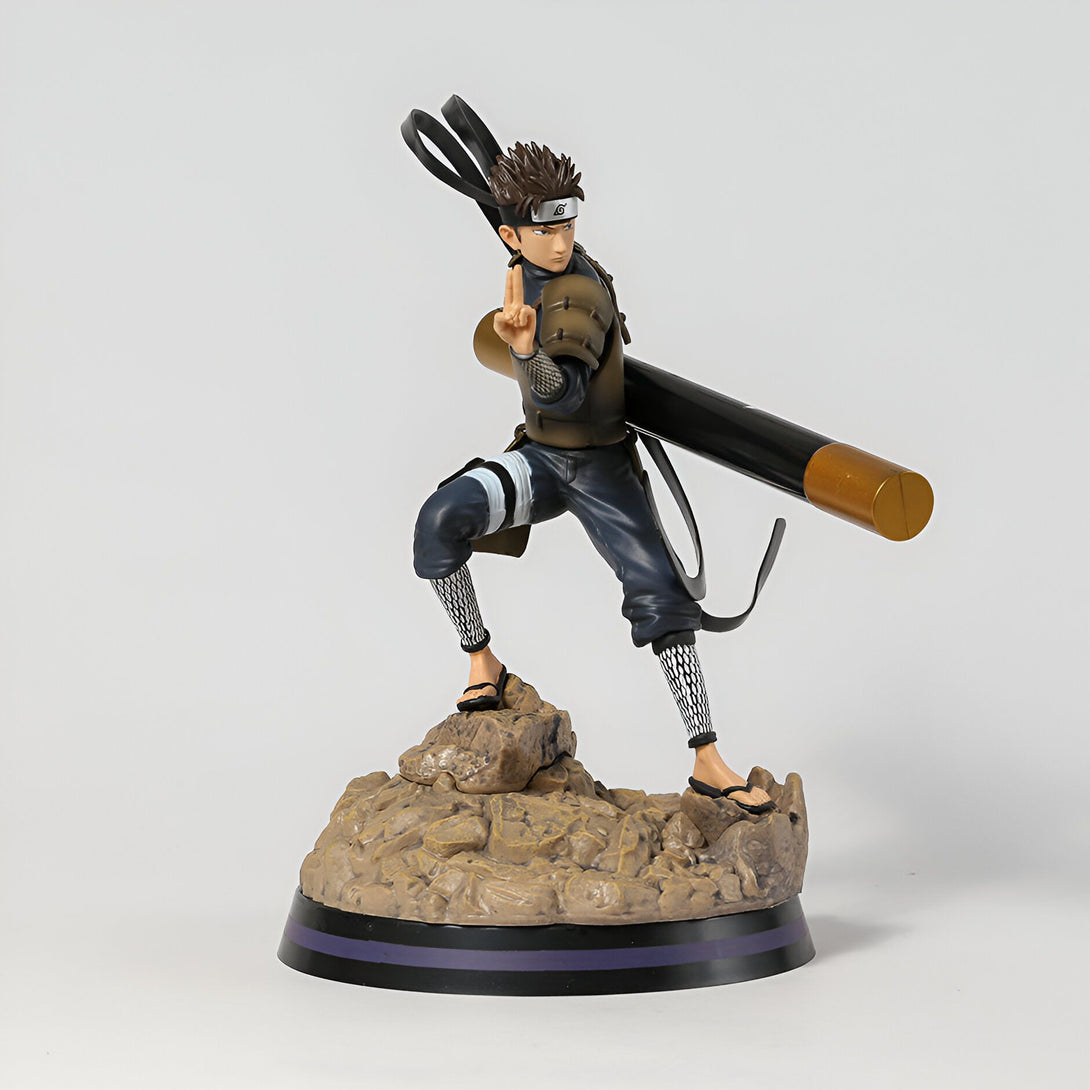 Figurine de  Kiba Inuzuka de Naruto Shippuden, debout sur un socle de roche, tenant un bâton de combat.