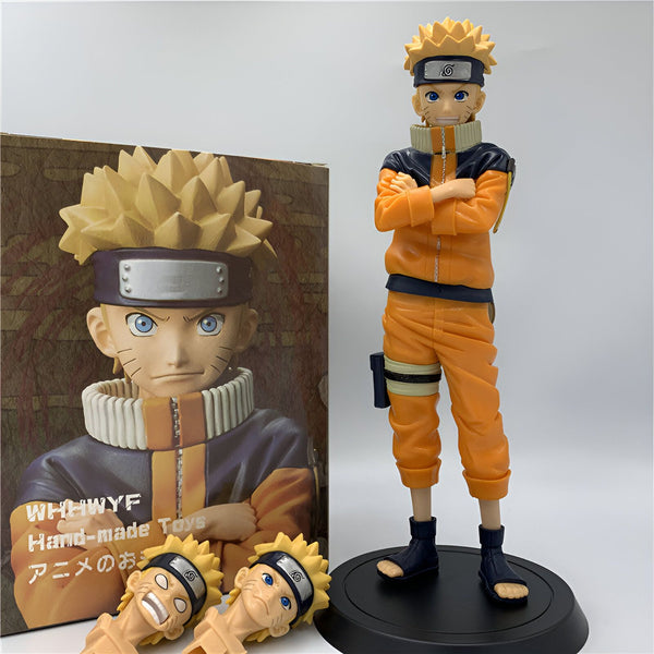 Figure de Naruto Uzumaki de l'anime Naruto, en tenue orange, les bras croisés. La figure est vendue avec un socle noir et des têtes interchangeables.