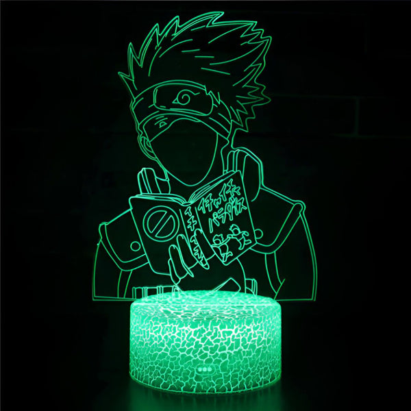 Lampe à LED 3D représentant Naruto Uzumaki en train de lire son livre de techniques interdites, avec une base de texture marbrée verte.