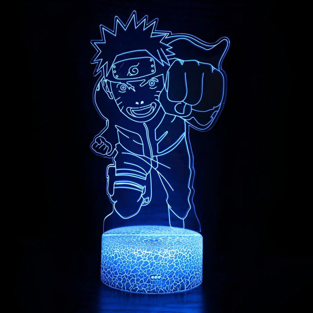 Lampe de nuit LED avec la silhouette de Naruto Uzumaki, le célèbre personnage de l'anime japonais Naruto, dans une pose dynamique avec son poing levé. La lampe est bleue et éclaire l'image de Naruto, qui est représenté avec son bandeau frontal et ses vêtements reconnaissables.