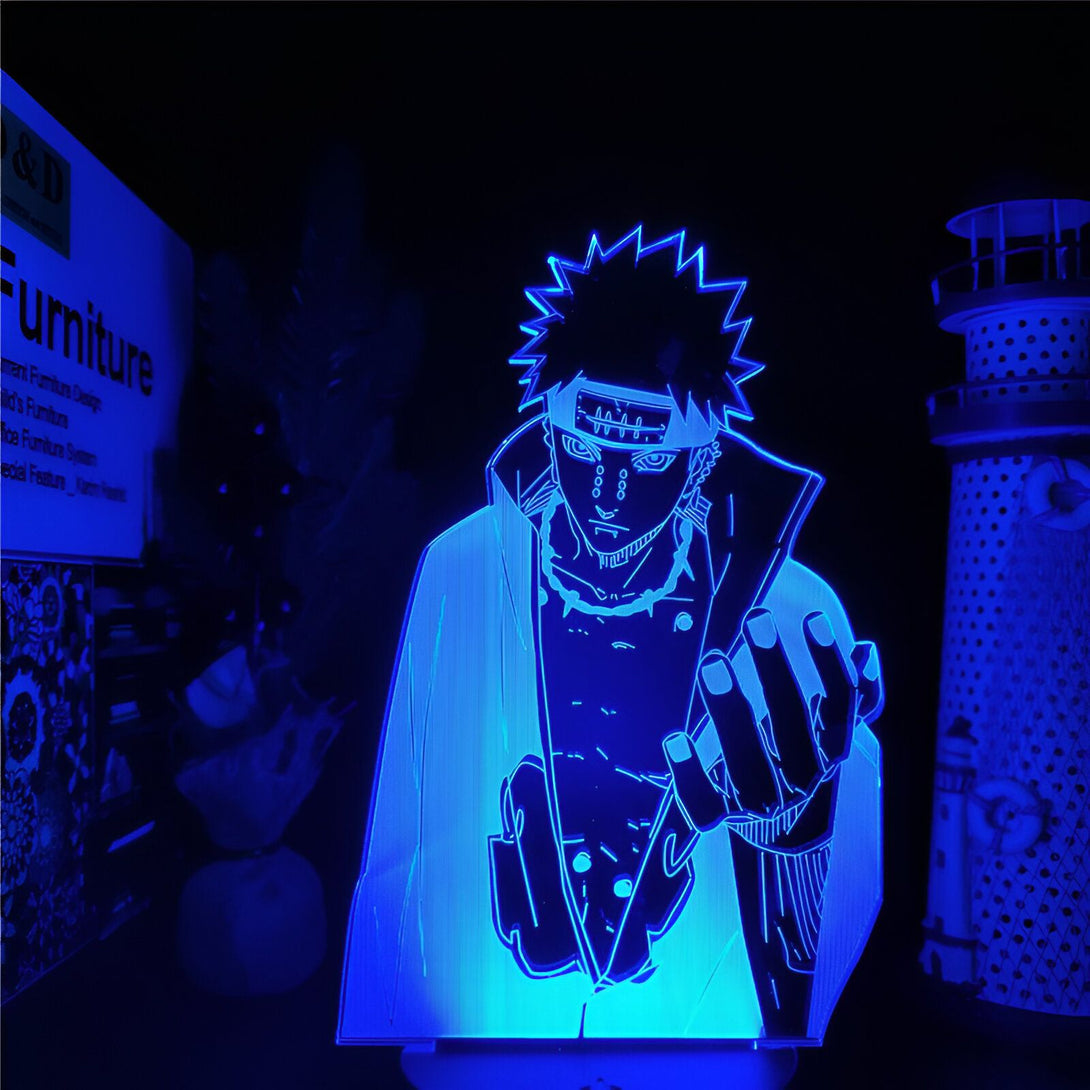 Lampe LED 3D de Pain, un personnage emblématique de l'anime Naruto, illuminant une pièce de manière unique. Son design et son style sont saisissants. La lumière bleue ajoute une touche de mystère et de magie à l'atmosphère. Cette lampe est un cadeau idéal pour tout fan de Naruto.
