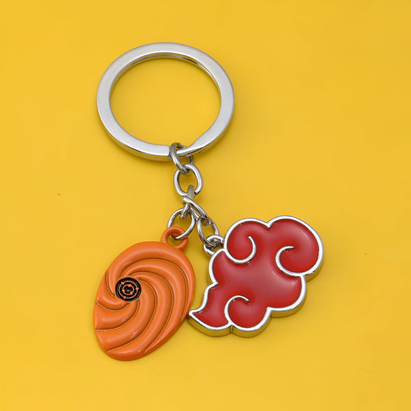 Porte-clés Naruto avec le symbole du Sharingan et le nuage rouge de l'Akatsuki.