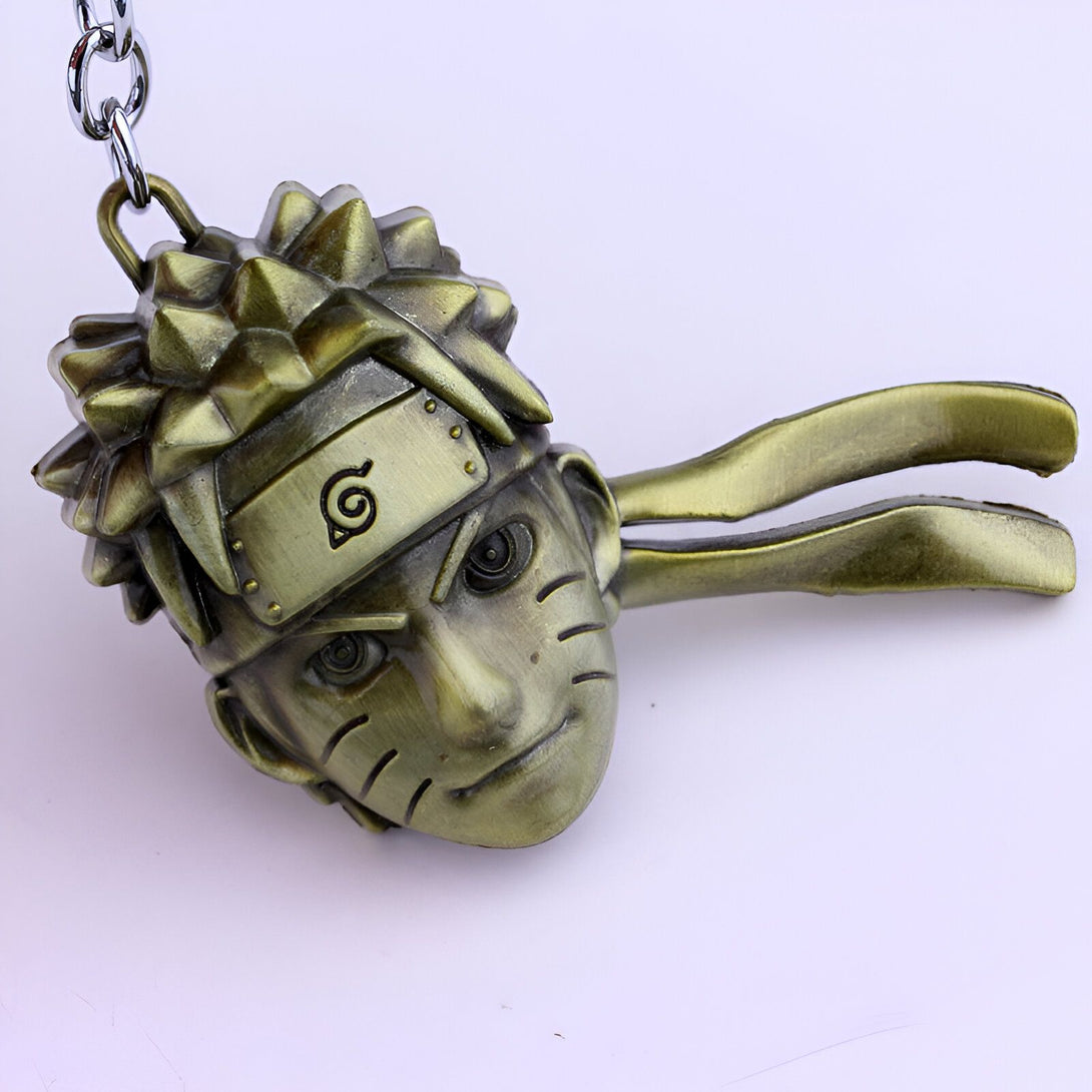 Porte-clés Naruto en métal avec la tête de Naruto Uzumaki, le bandeau du village de Konoha et son symbole.