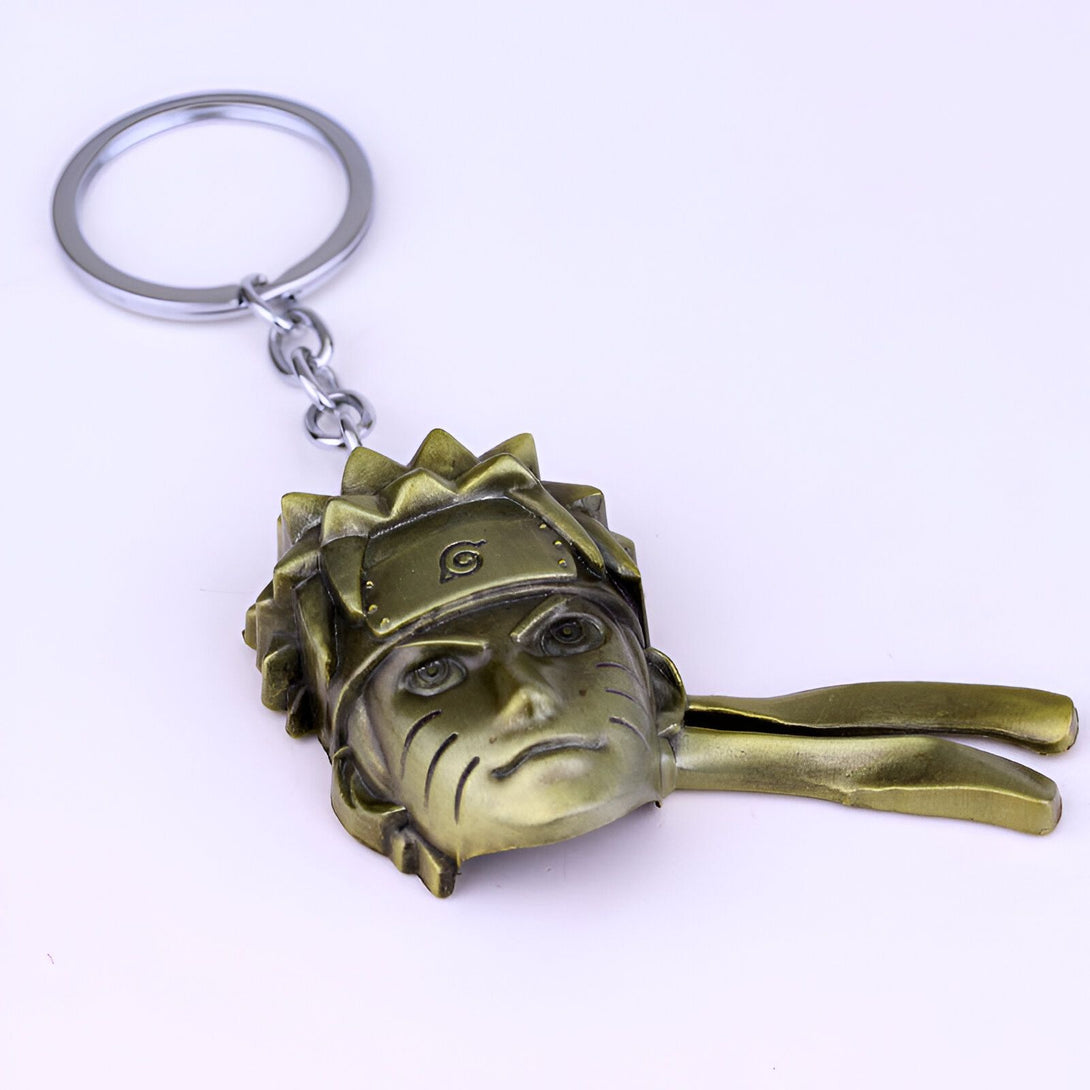 Porte-clés en métal représentant le visage de Naruto Uzumaki, un personnage de l'anime Naruto. Le porte-clés est de couleur dorée et comporte le symbole du clan Uzumaki.
