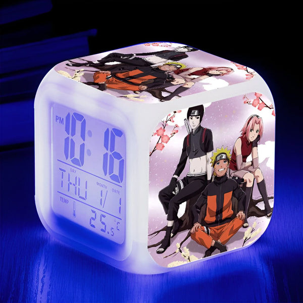 Horloge numérique avec affichage de la température, avec un design Naruto. L'horloge affiche "10:16" avec "THU/1" pour le jour et la date. On y voit Naruto, Sasuke et Sakura.